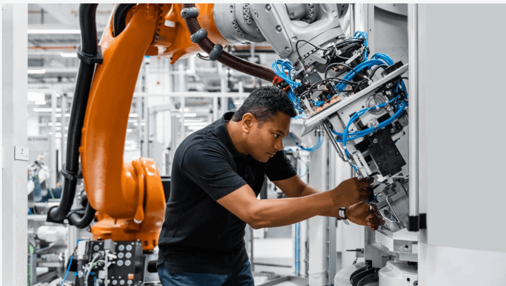 A man working on an industrial machine.