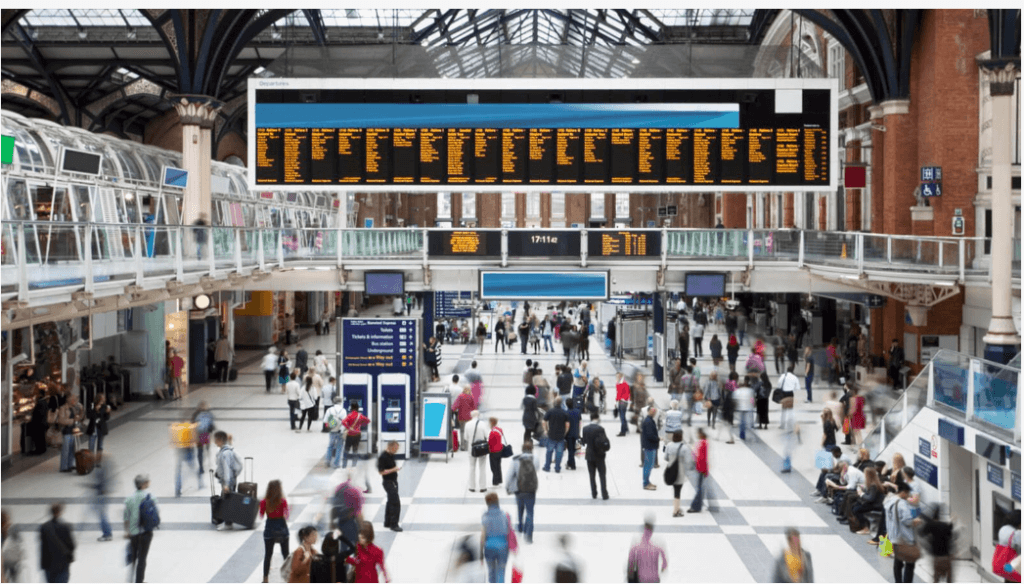 A busy train station with people walking around.