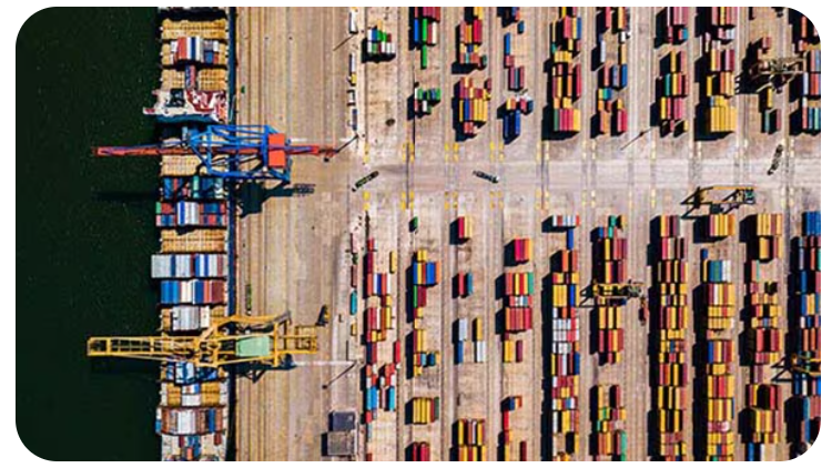 A large cargo port with many containers and cranes.